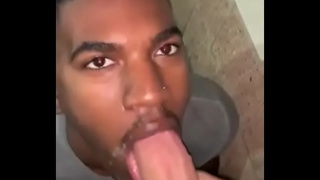 Black jock gives a sloppy blowjob to his white teammate after the game